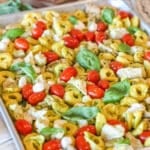 Caprese chicken and tortellini on a sheet pan after baking.