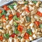 Overhead shot of sheet pan hot honey chicken and veggies on a baking sheet.