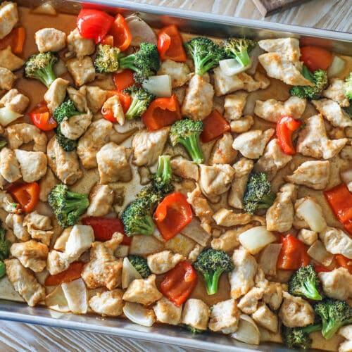 Finished sheet pan hot honey chicken with veggies in the baking sheet.