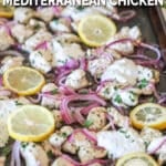 Side view of sheet pan Mediterranean chicken with red onions and lemons.
