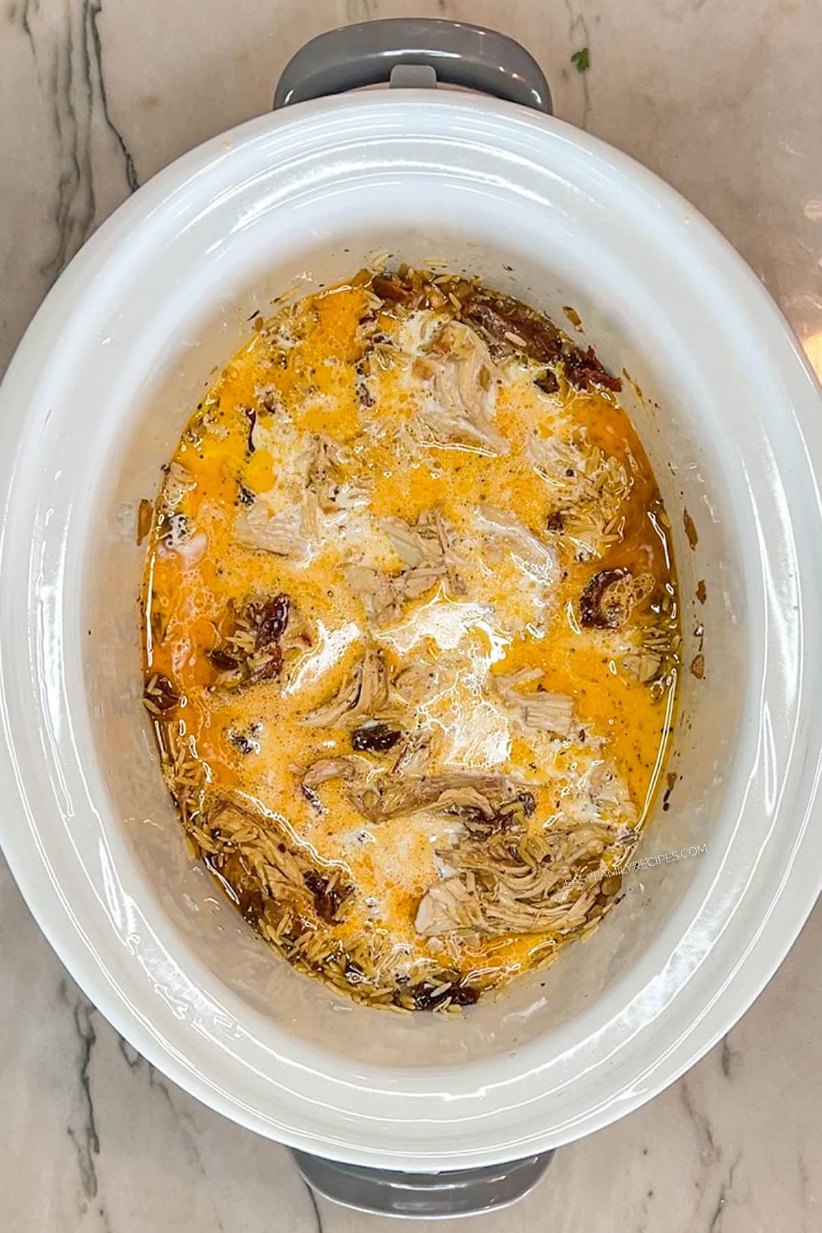 Heavy cream and chicken broth added to the orzo to cook in the crockpot.