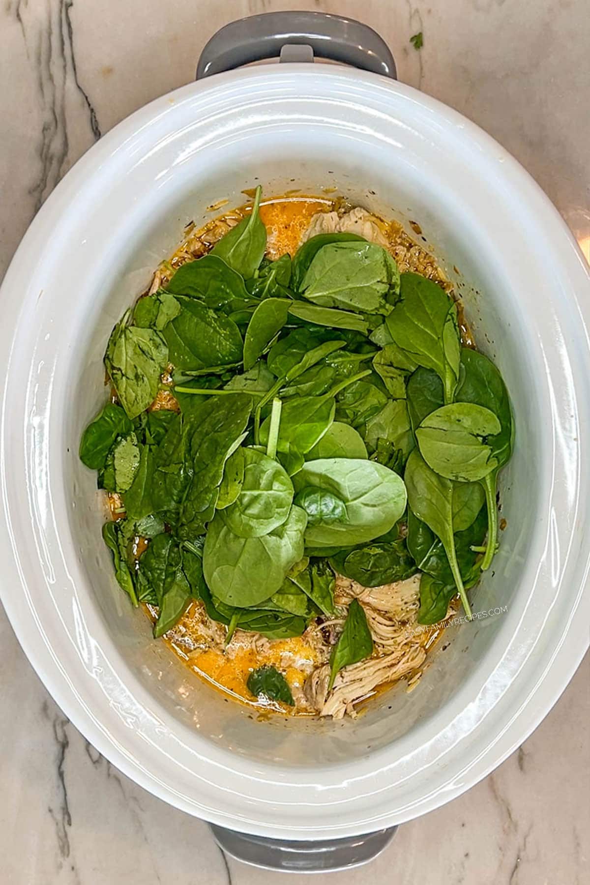 Spinach added to the crockpot Tuscan chicken.
