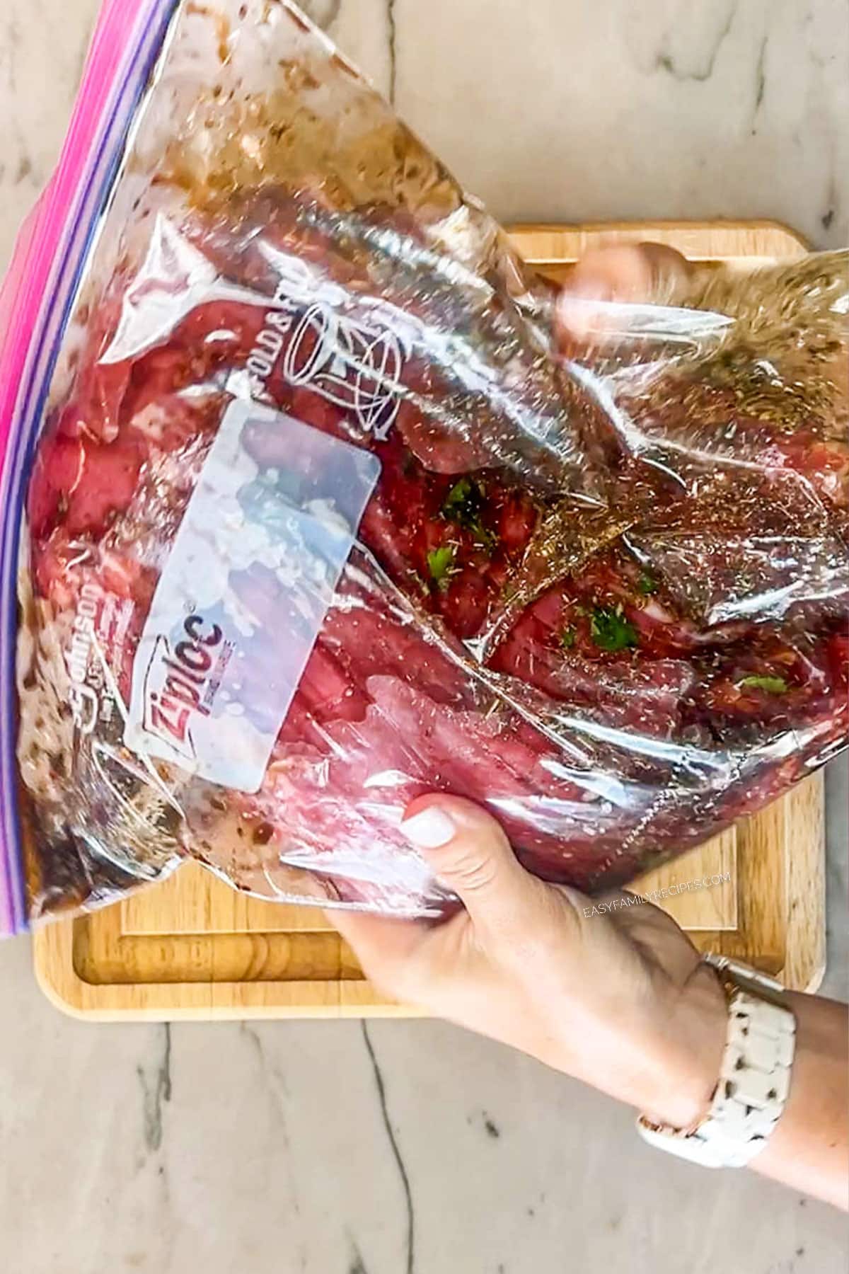 Step 3 for how to make flank steak marinade- work bag with steak and marinade inside to coat steak