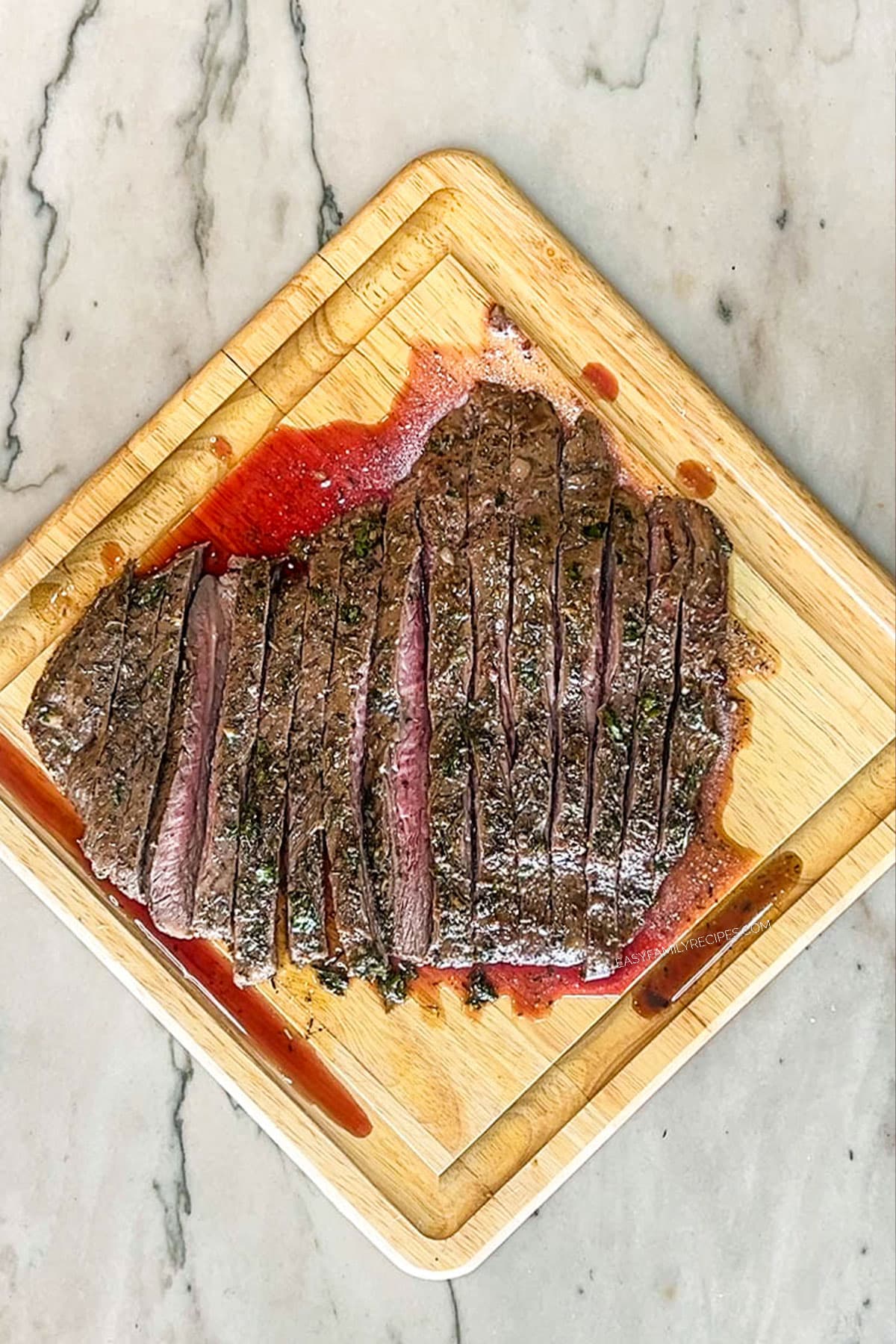 Step 6 for how to make flank steak marinade- slice steak against grain- on cutting board