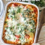 Overhead shot of finished ravioli lasagna in a white baking dish.
