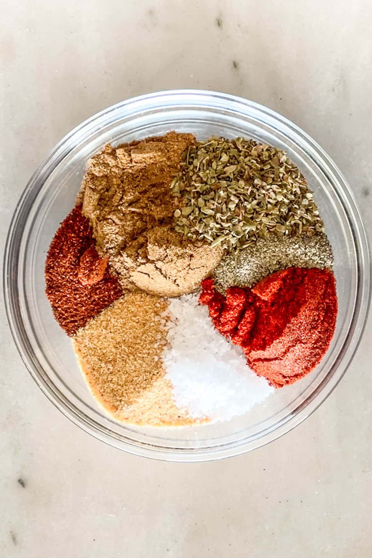 The various spices for Carne Asada Seasoning Blend in a clear bowl