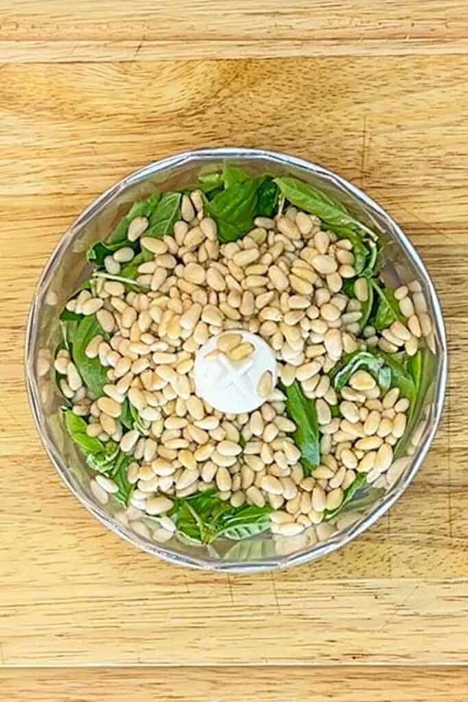 basil and pine nuts in a food processor.