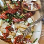 above image of goat cheese log appetizer on a serving plate.