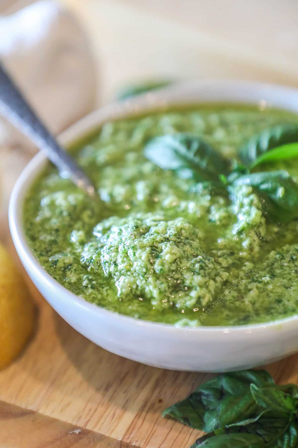 homemade pesto garnished with fresh basil in a bowl.