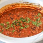 Finished crockpot taco chili in the slow cooker garnished with cilantro.