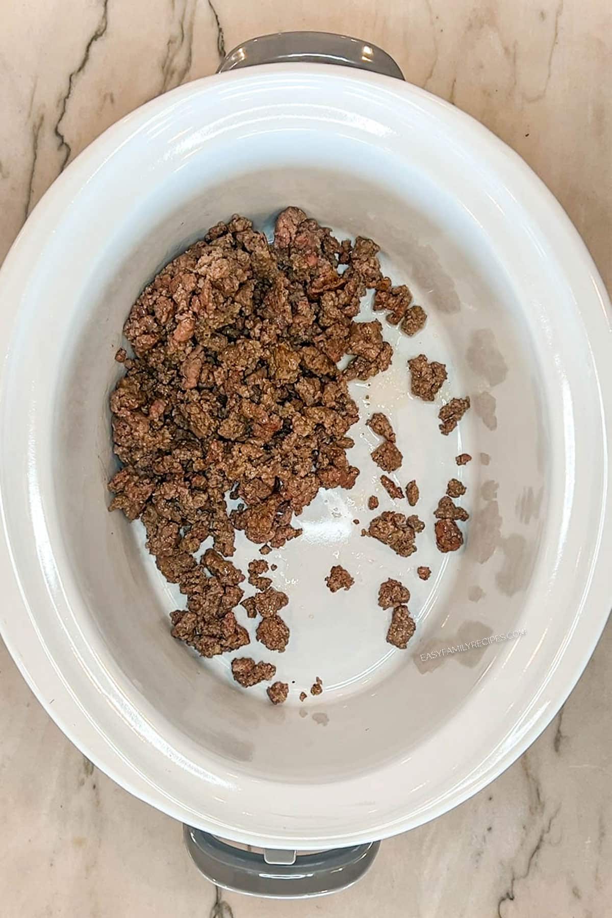 Browned ground beef added to the crockpot.