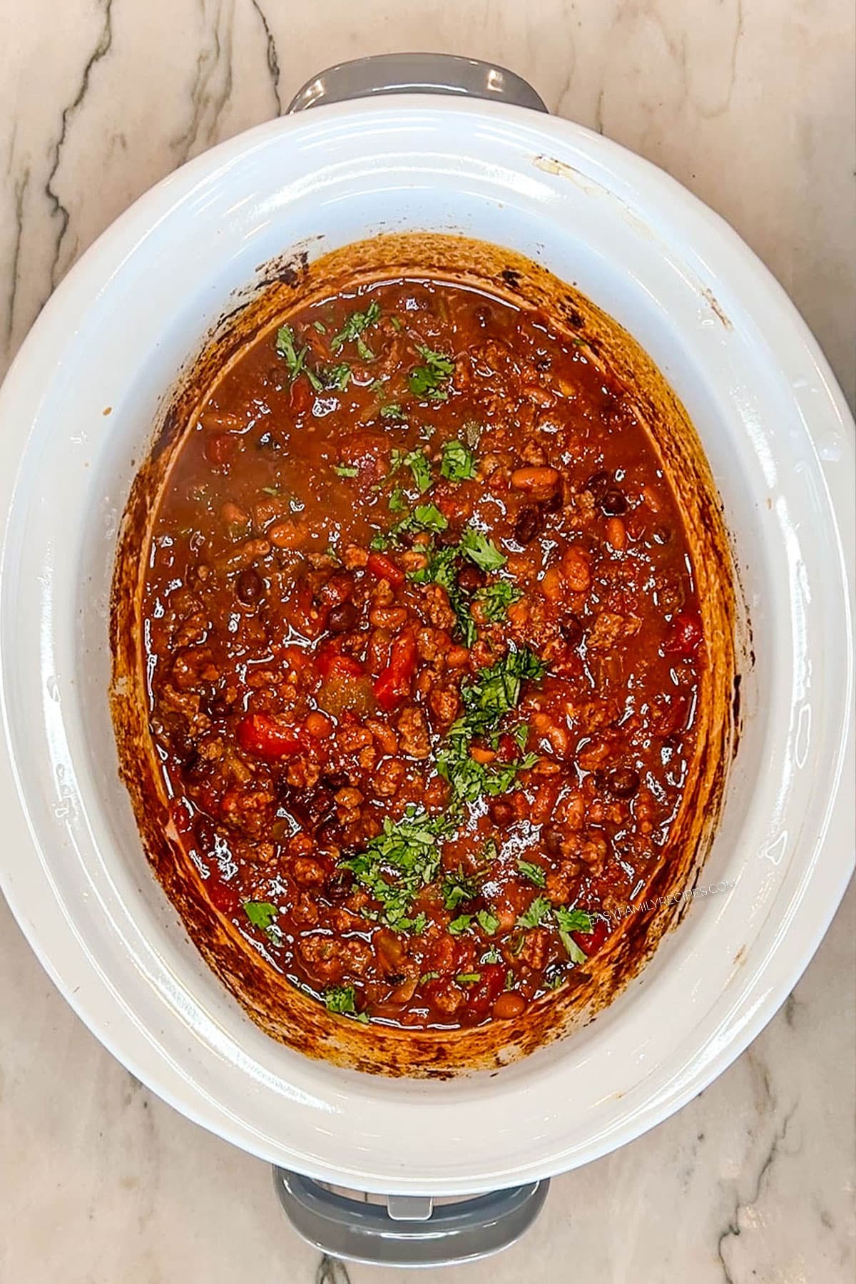 Taco chili in the crockpot with cilantro on top.