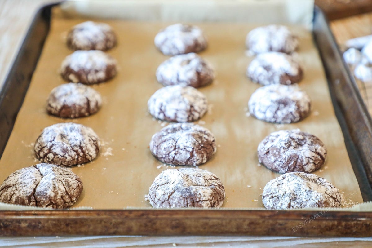 Baked Brownie Crinkle Cookies- on a parchment paper lined sheet pan