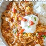 Crockpot Enchilada Chicken Casserole with a side of rice on a white dish.