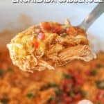 Crockpot Enchilada Chicken Casserole in white crockpot with spoon lifting out