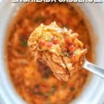 Crockpot Enchilada Chicken Casserole in white crockpot with spoon lifting out