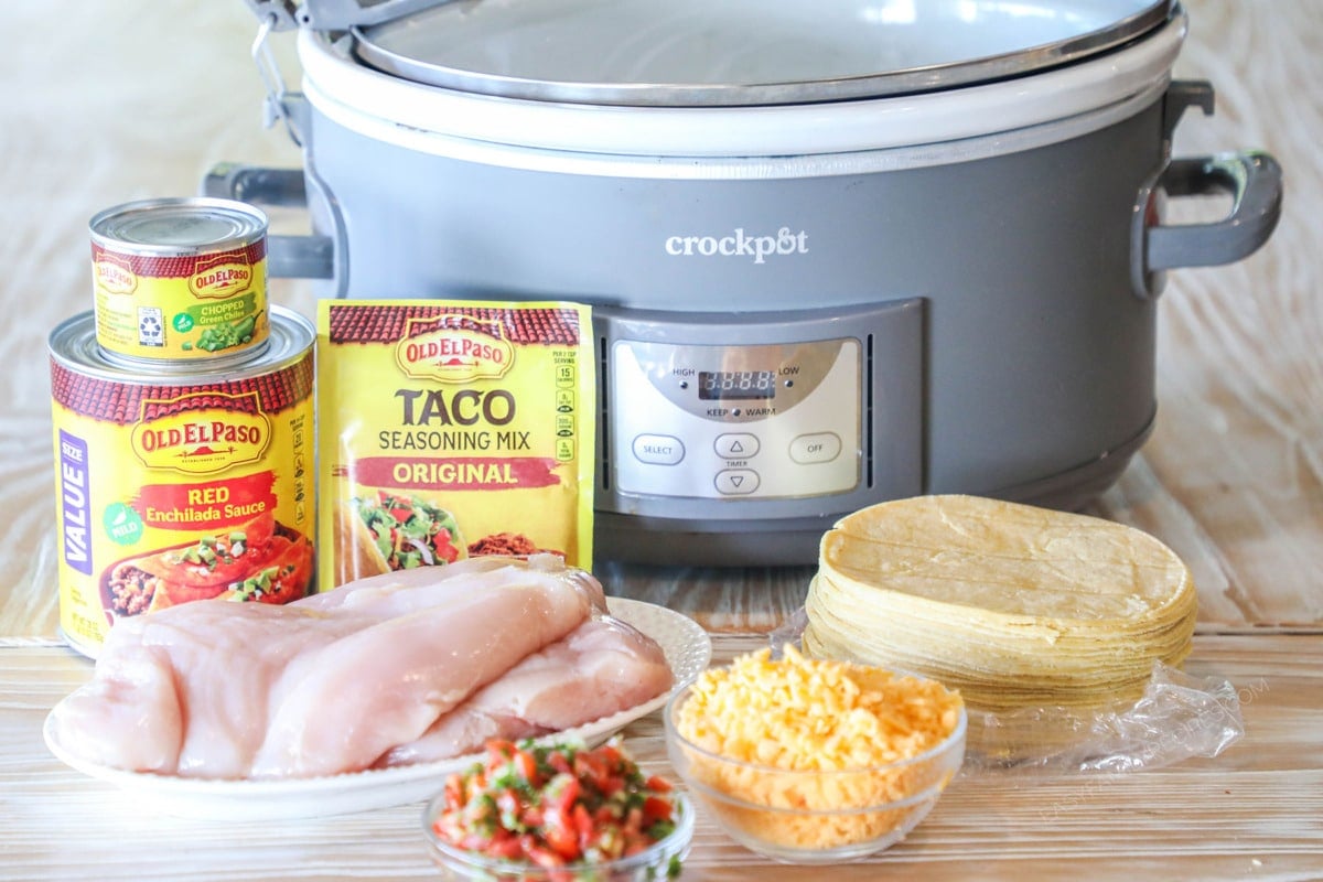 Ingredients needed to make Crockpot Enchilada Chicken Casserole. Grey crockpot in background