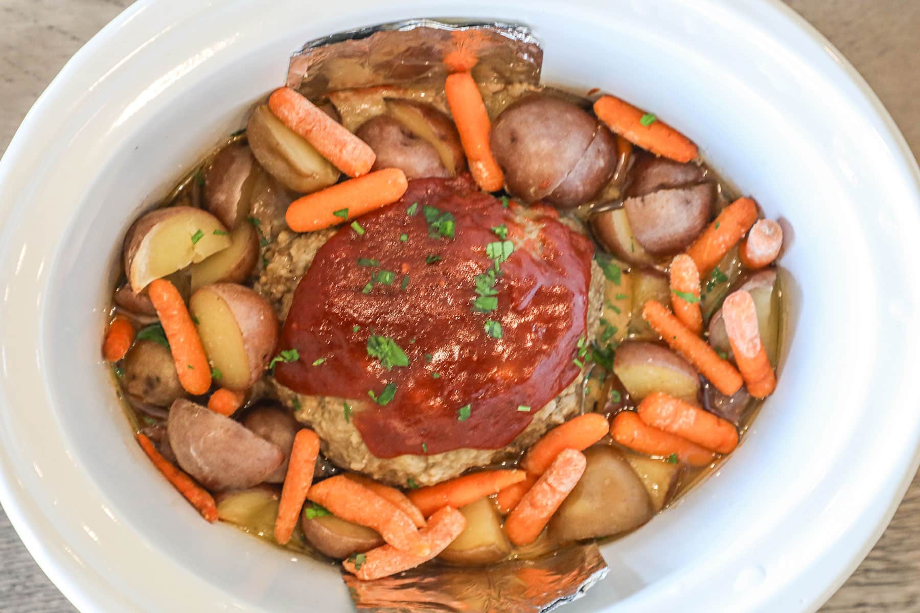 Crockpot Meatloaf and Potatoes- in a white crockpot