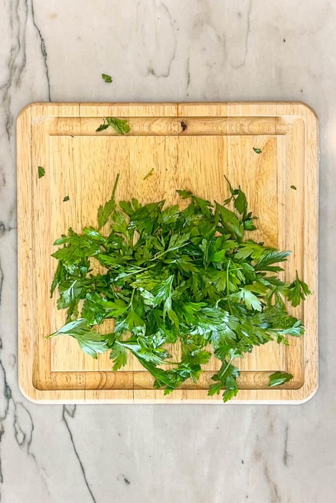 fresh parsley on a cutting board.