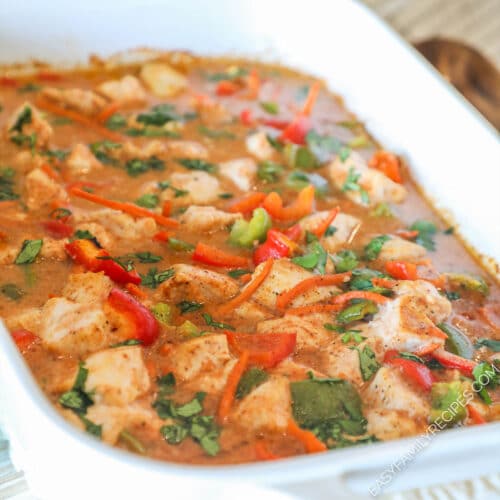 Finished baked chicken curry in a baking dish topped with cilantro.
