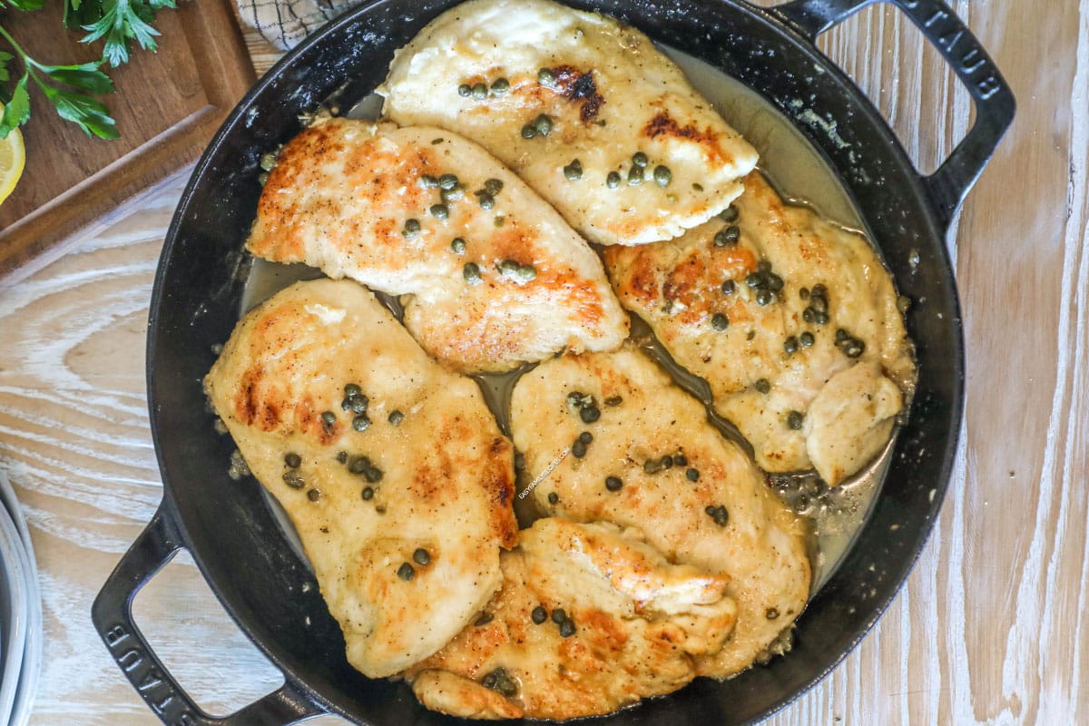 Overhead shot of chicken piccata in a skillet.