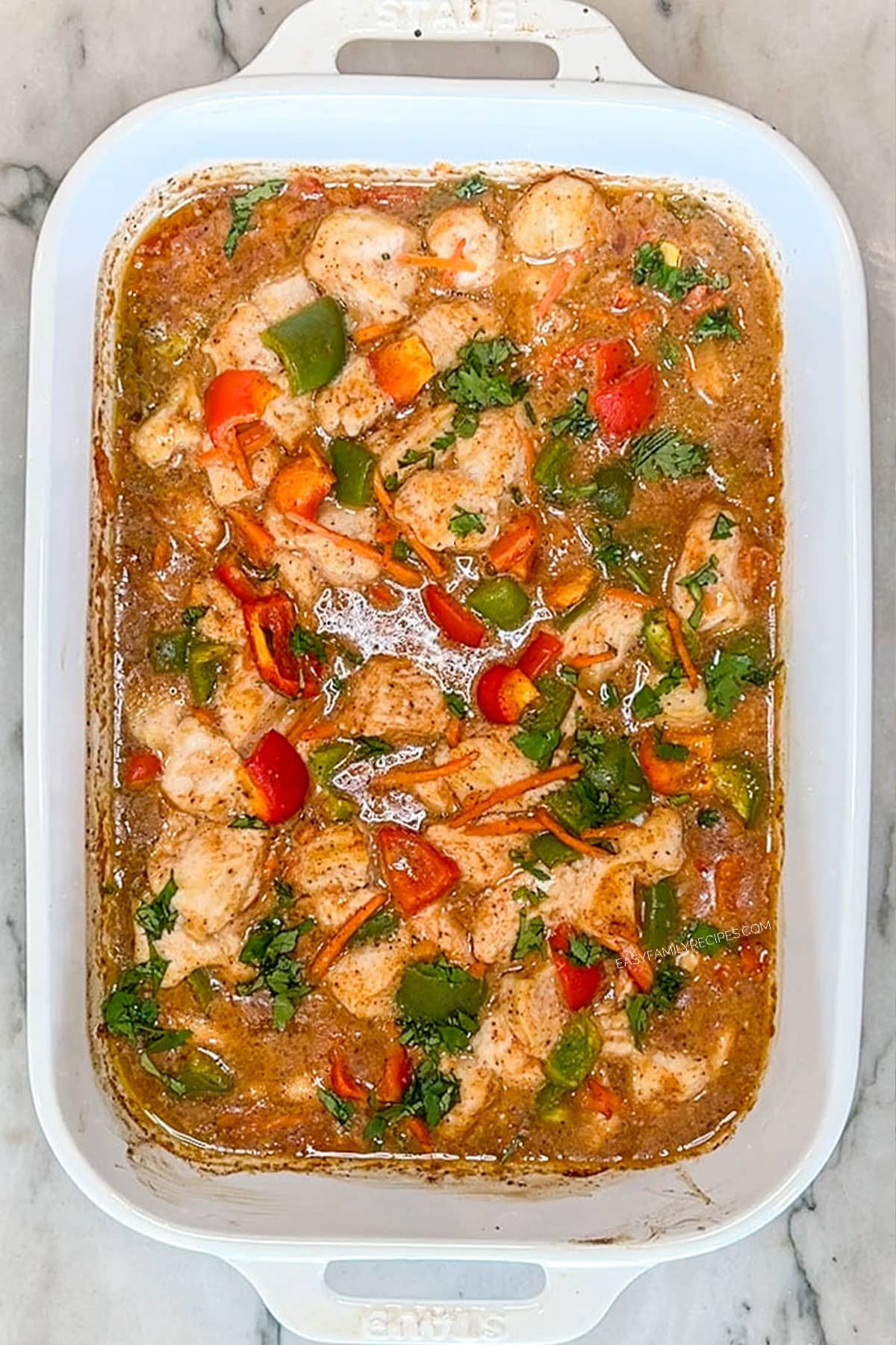 Baked chicken curry in a baking dish after coming out of the oven.