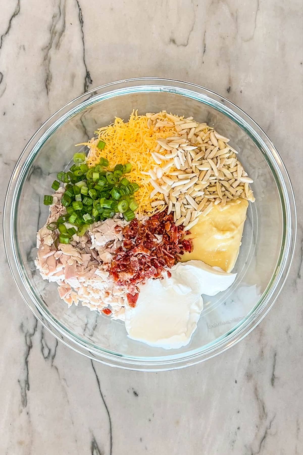 Step 3 for making Neiman Marcus Chicken Casserole- combine casserole filling ingredients in large bowl