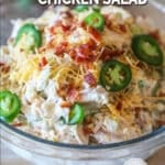 Glass bowl of Jalapeño Popper Chicken Salad on a wooden background.