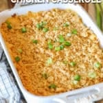 Neiman Marcus Chicken Casserole in white baking dish on a wooden background with a kitchen towel