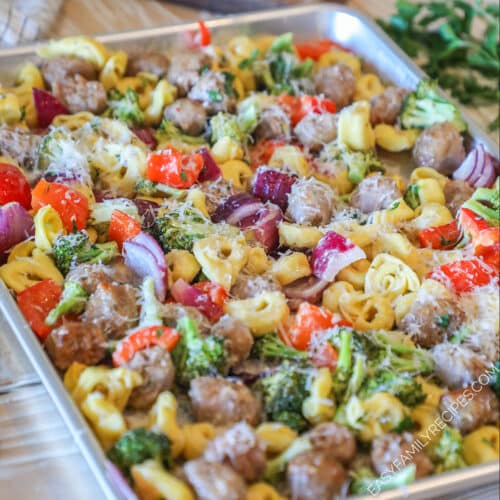 Sheet Pan Italian Sausage and Cheese Tortellini on a wooden background