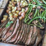 a sheet pan loaded with easy marinated flank steak, roasted mushrooms, green beans, and potatoes.