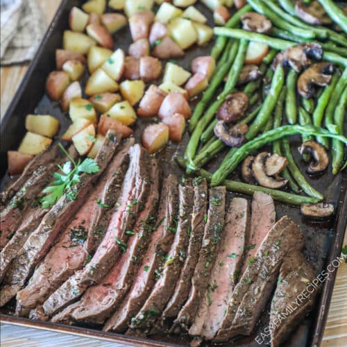 a sheet pan loaded with easy marinated flank steak, roasted mushrooms, green beans, and potatoes.
