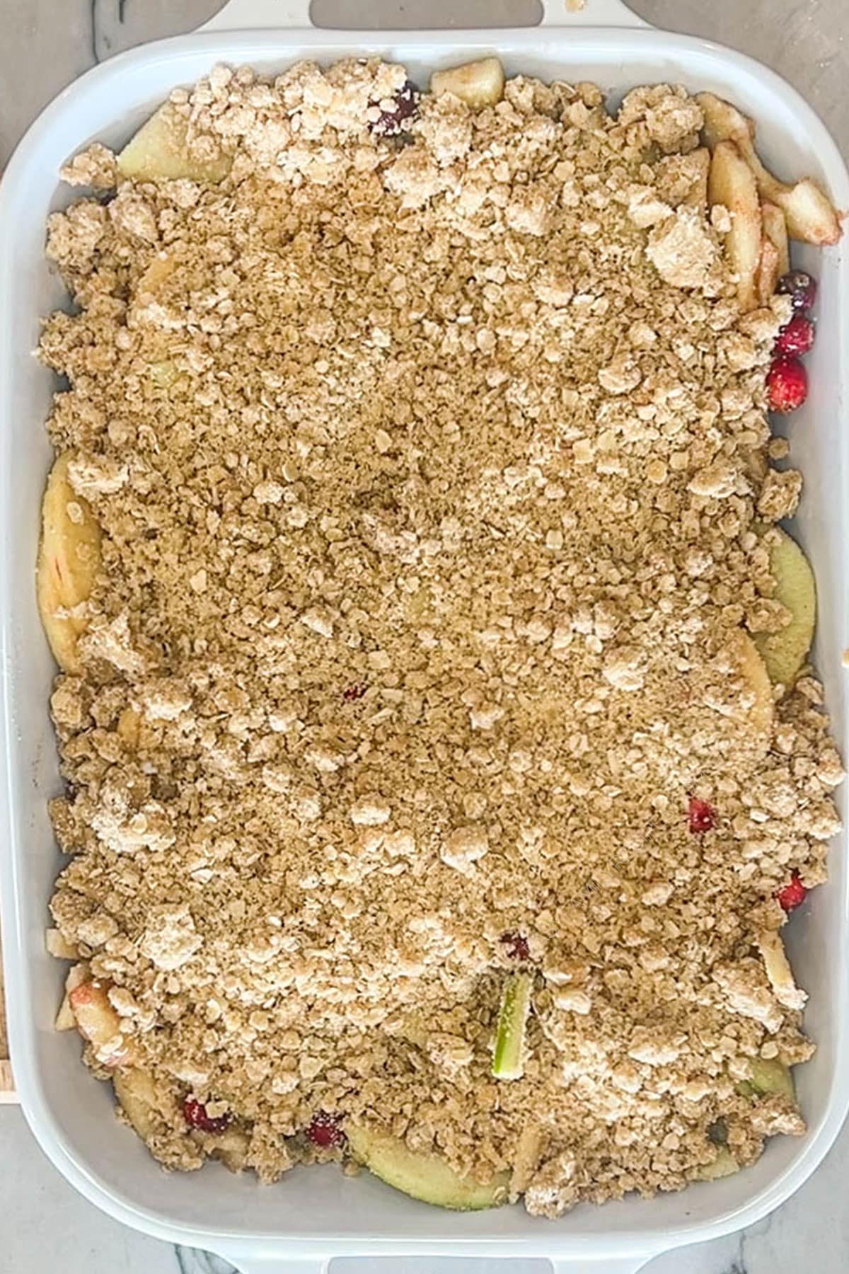 Assembled apple cranberry crumble before baking.