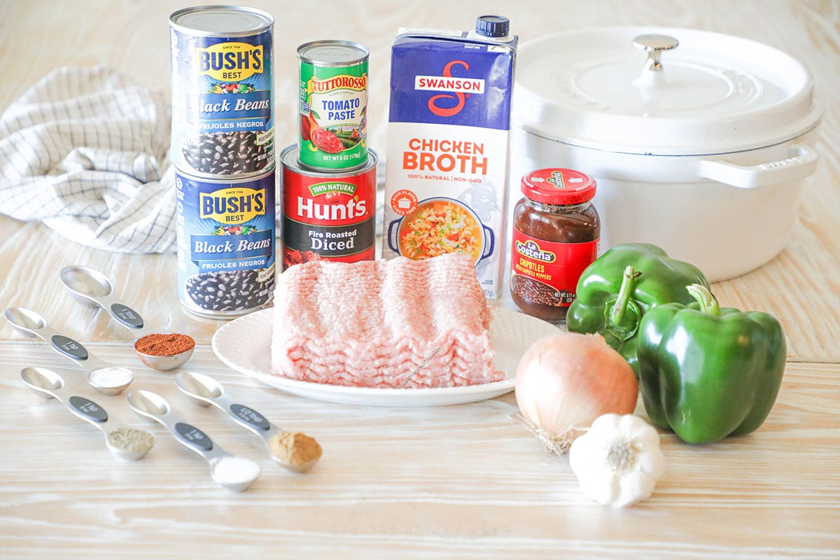 Ingredients needed to make Chipotle Black Bean Ground Turkey Chili- on a wooden background