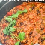 Close up of Chipotle Black Bean Ground Turkey Chili in a large, white pot