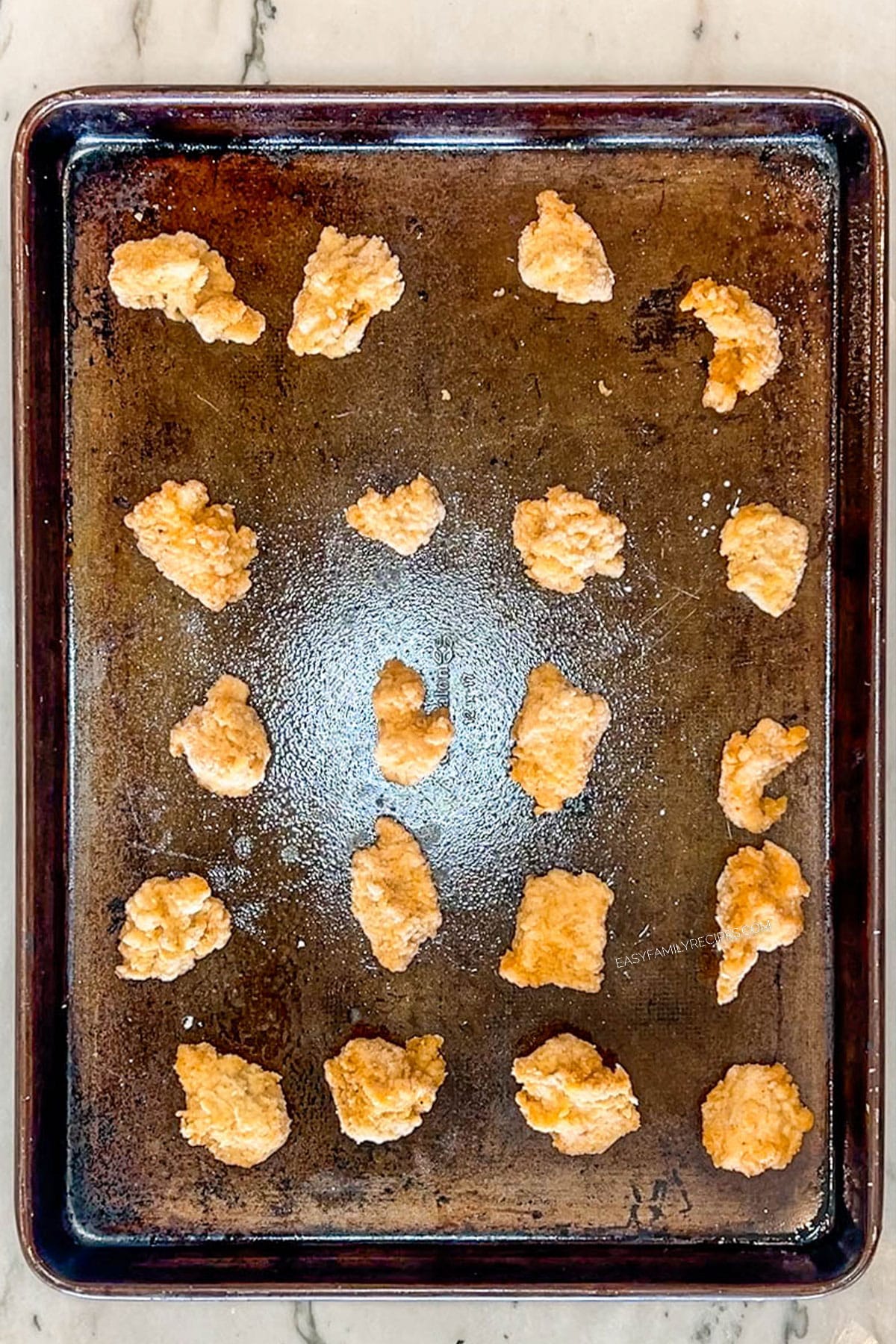 Step 3 for making Chicks in a Blanket. Arrange 24 nuggets on baking sheet.
