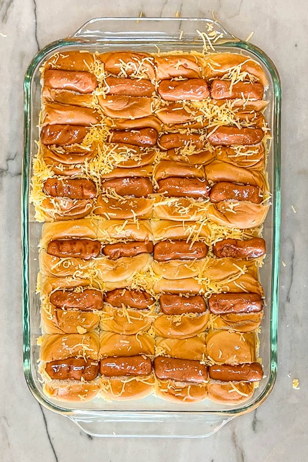 Step 3 for making Chili Dog Sliders. Place Little Smokies sausage in each bun