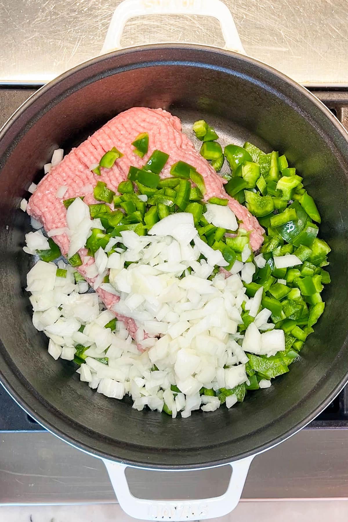 Step 1 for making Chipotle Black Bean Ground Turkey Chili- cook ground turkey, diced onion and green bell pepper
