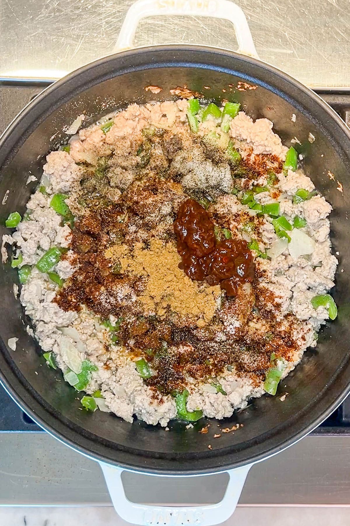 Step 2 for making Chipotle Black Bean Ground Turkey Chili- add chili seasoning blend and chipotle peppers