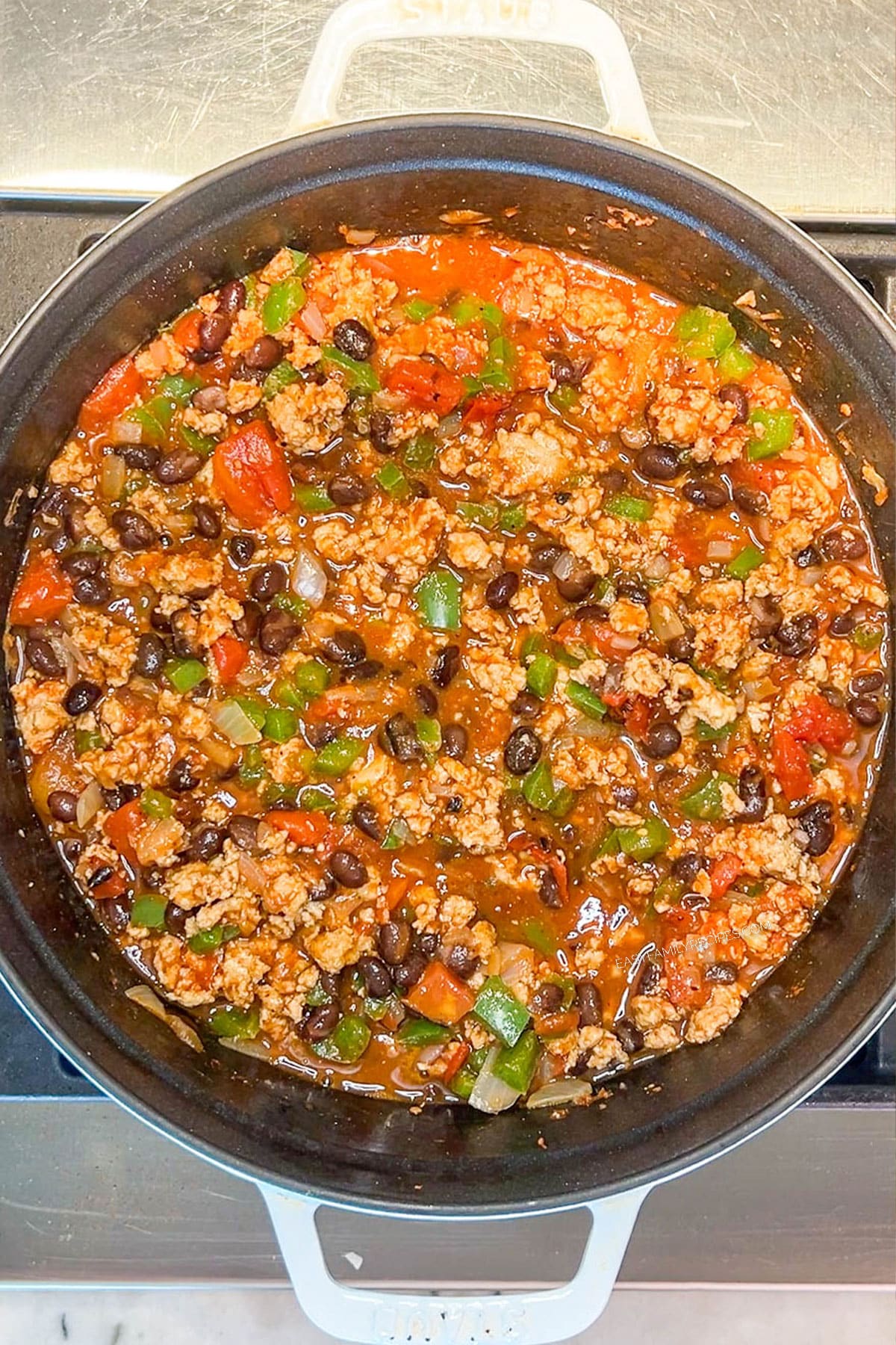 Step 6 for making Chipotle Black Bean Ground Turkey Chili- stir to combine and simmer