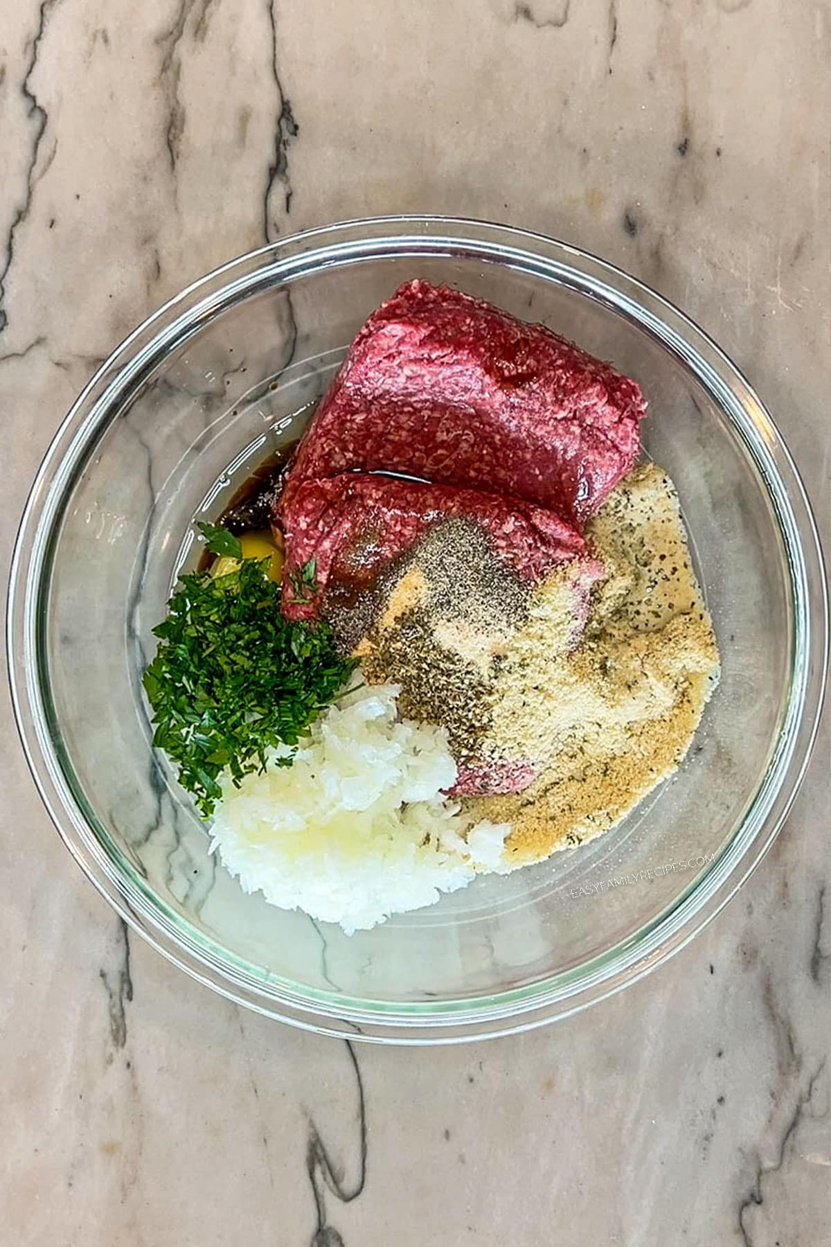 Step 1 for making Mini Meatloaf Sheet Pan Dinner. Combine all ingredients for the meatloaf in a large bowl.