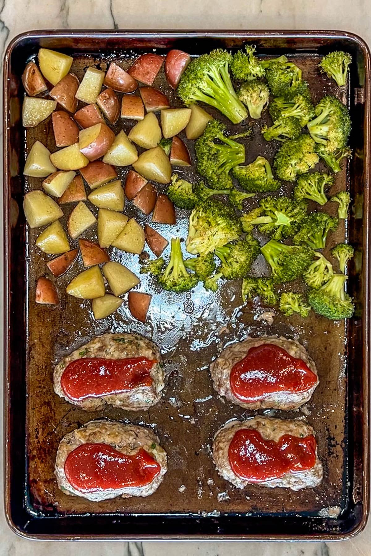 Step 4 for making Mini Meatloaf Sheet Pan Dinner. Bake all together on sheet pan.
