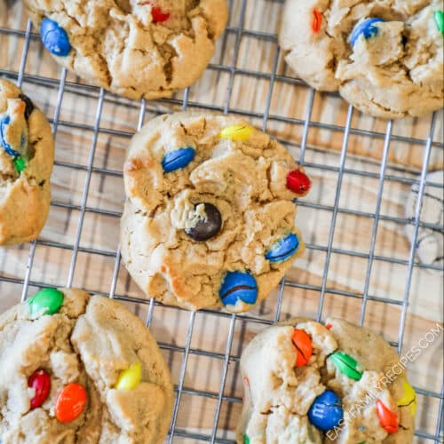 above image of finished peanut butter M&M cookies on a cooling rack.