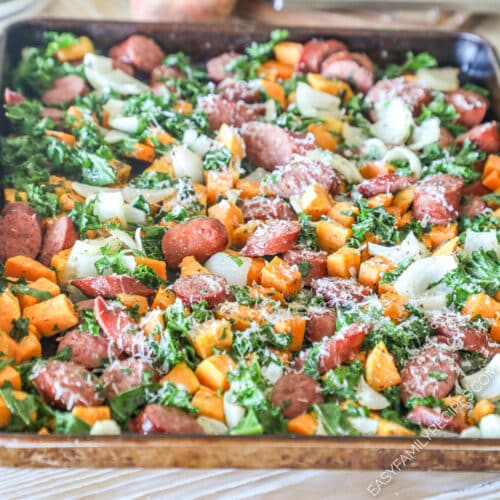 Sheet pan sausage and sweet potatoes with kale, onions, and Parmesan.