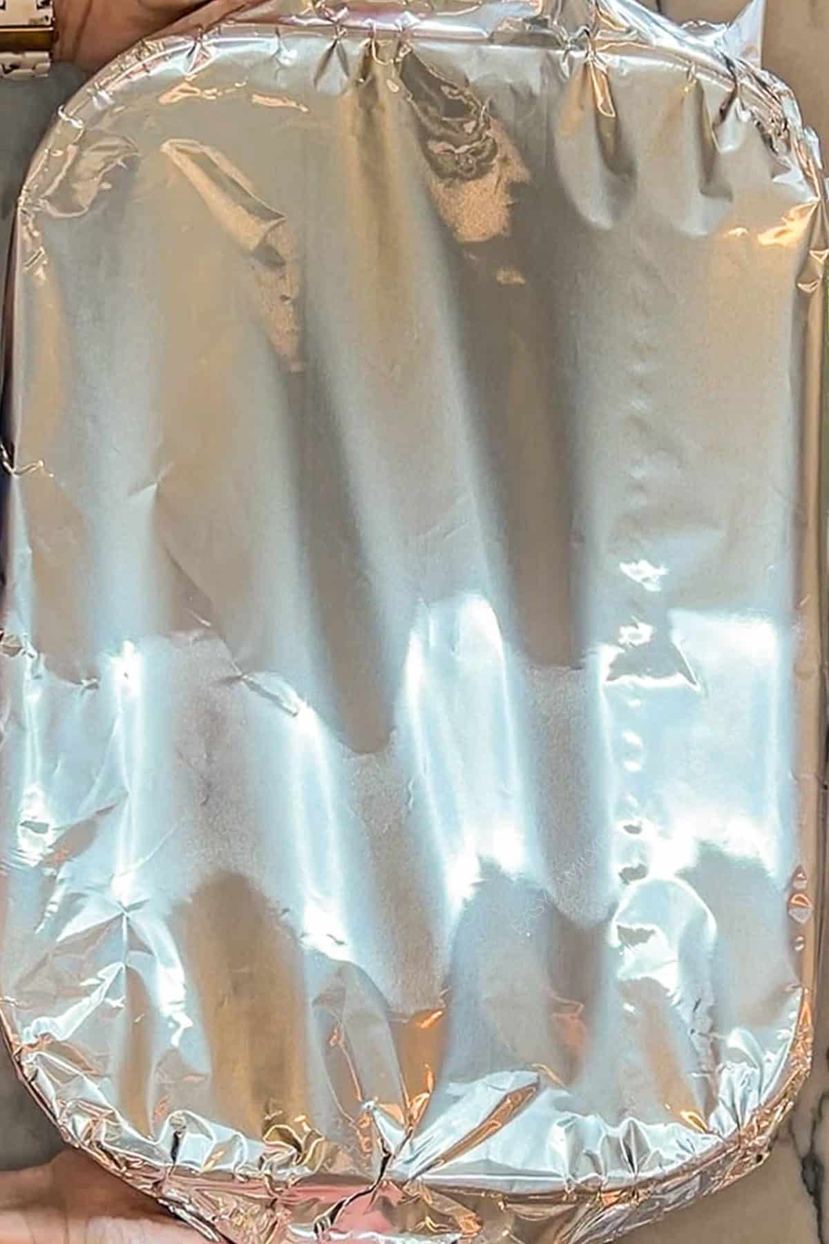 Foil placed on top of pasta baking dish.