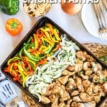 Baked Chicken Fajitas on a sheet pan with bell peppers and onions.