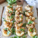 Pear and Gorgonzola Puff Pastry Bites with chopped arugula- on a wooden board- on a wooden background