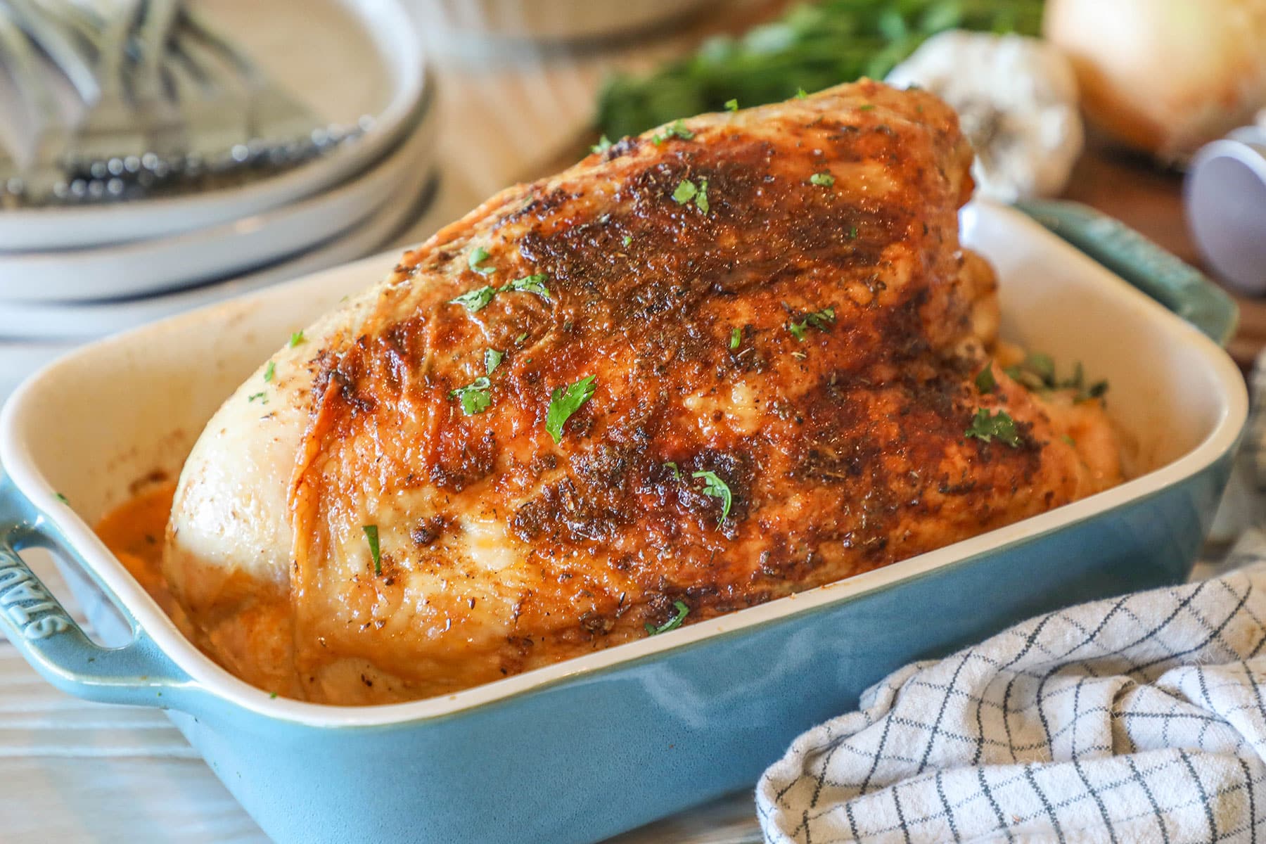 finished roasted turkey breast in a baking dish.