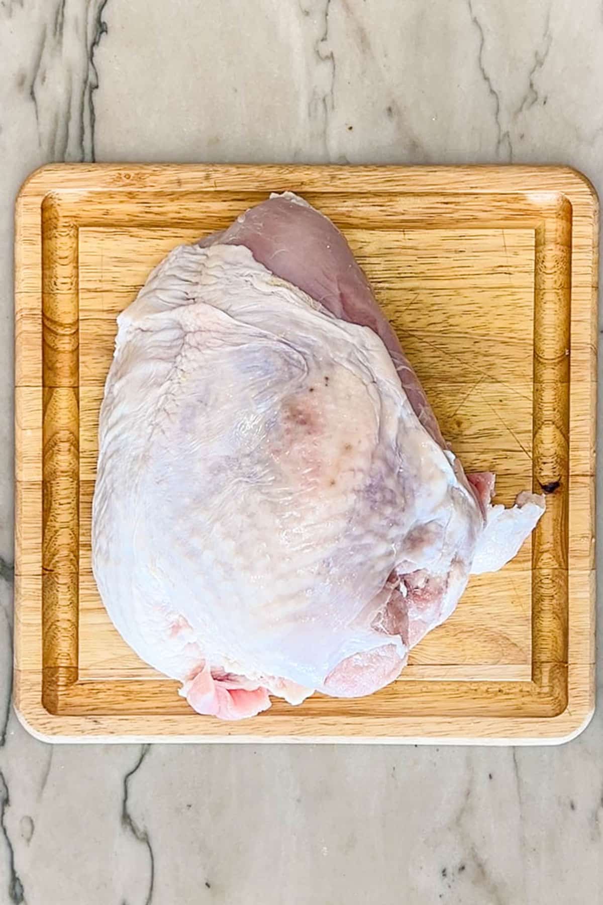 turkey breast on a cutting board.