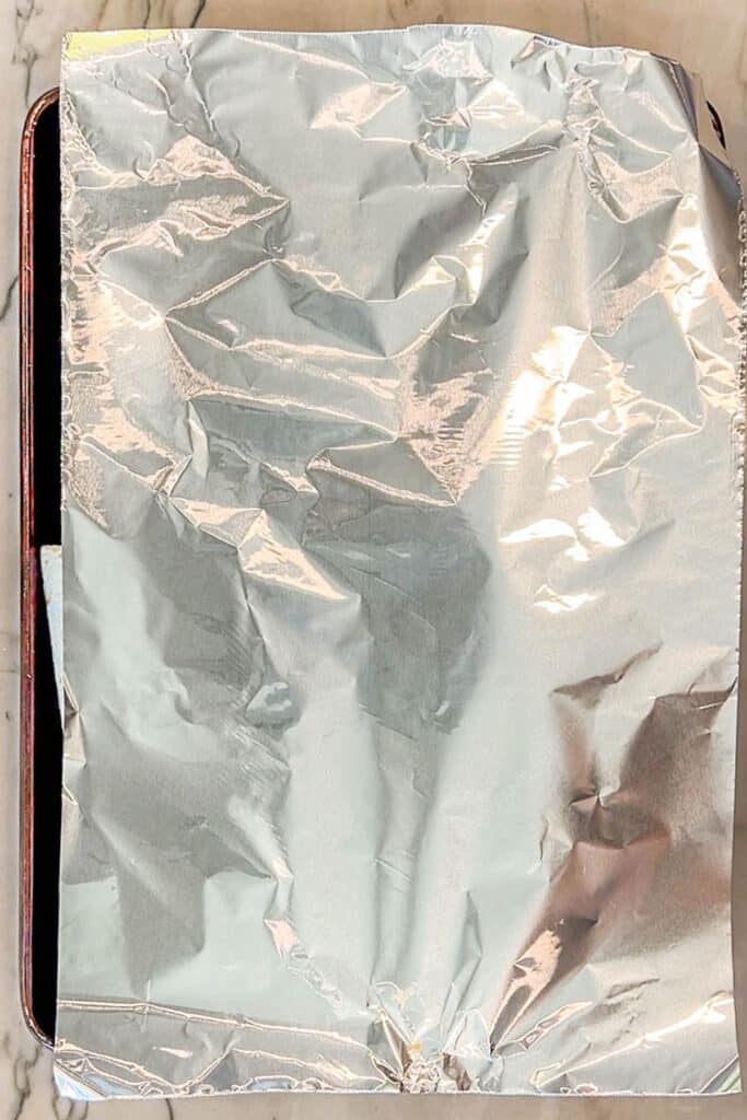 Foil covering sheet pan crunch wrap supreme.